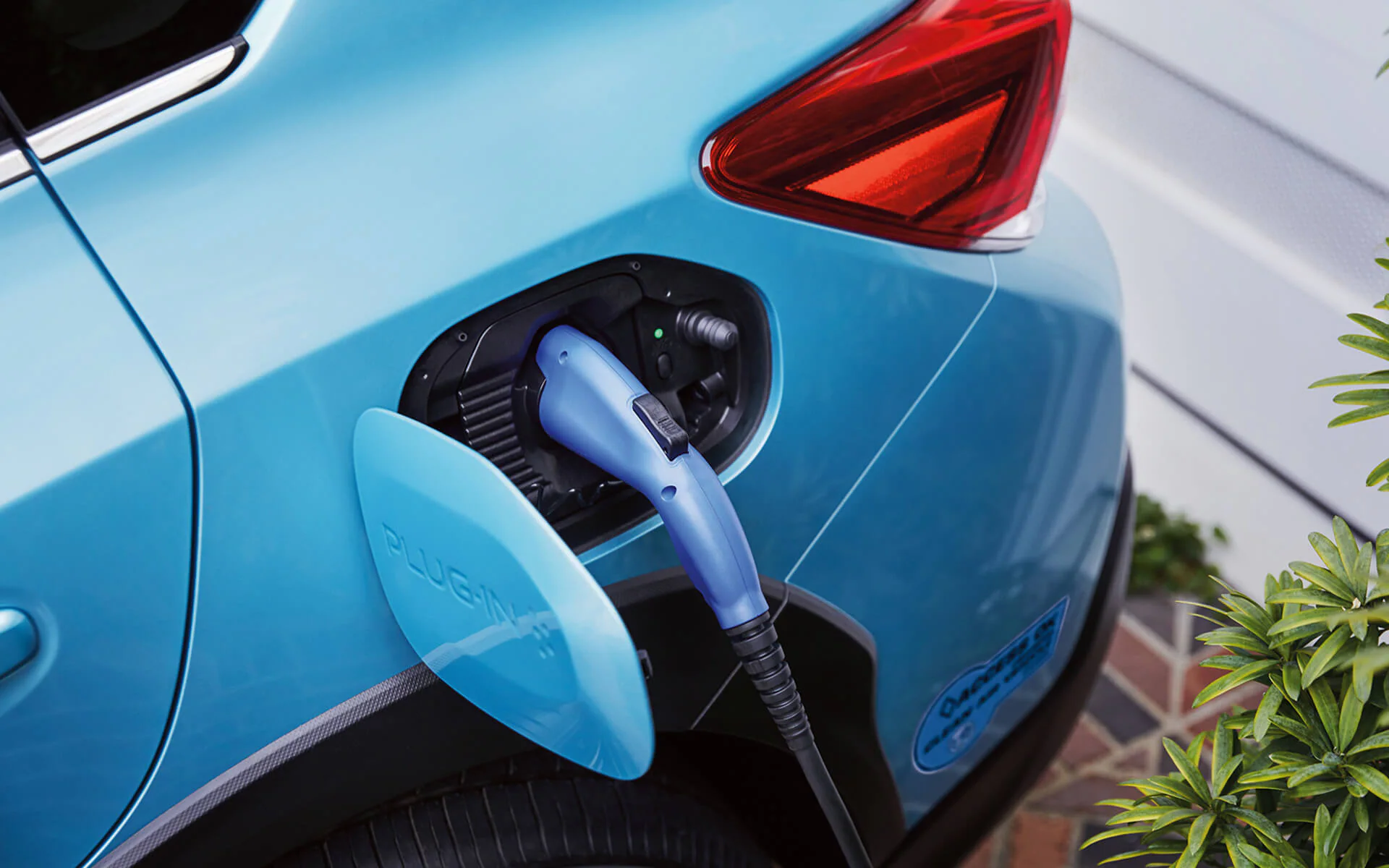 A close-up of the Subaru Crosstrek Hybrid’s charging port with charging cable plugged in
