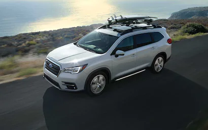 Silver Subaru Ascent driving on a scenic coastal highway