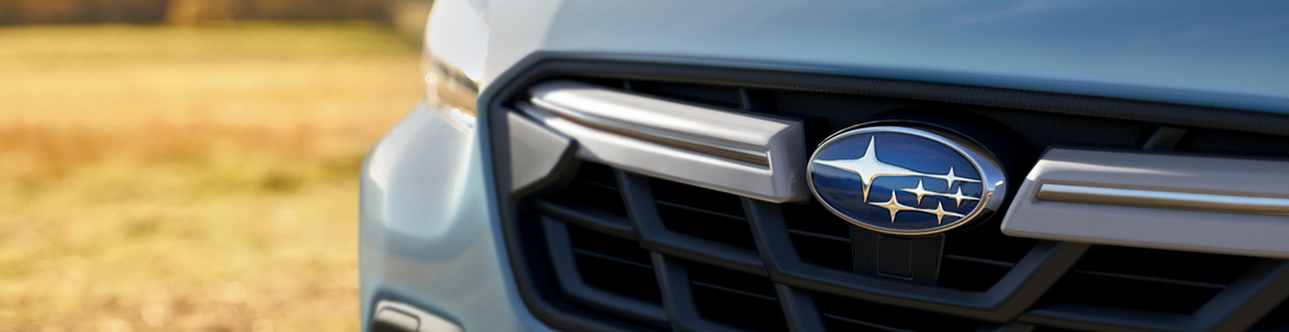Closeup of Subaru emblem and grille